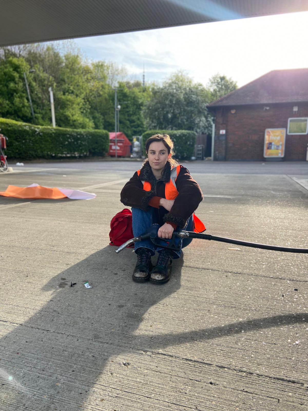 Rosa Sharkey is glued onto a petrol pump.