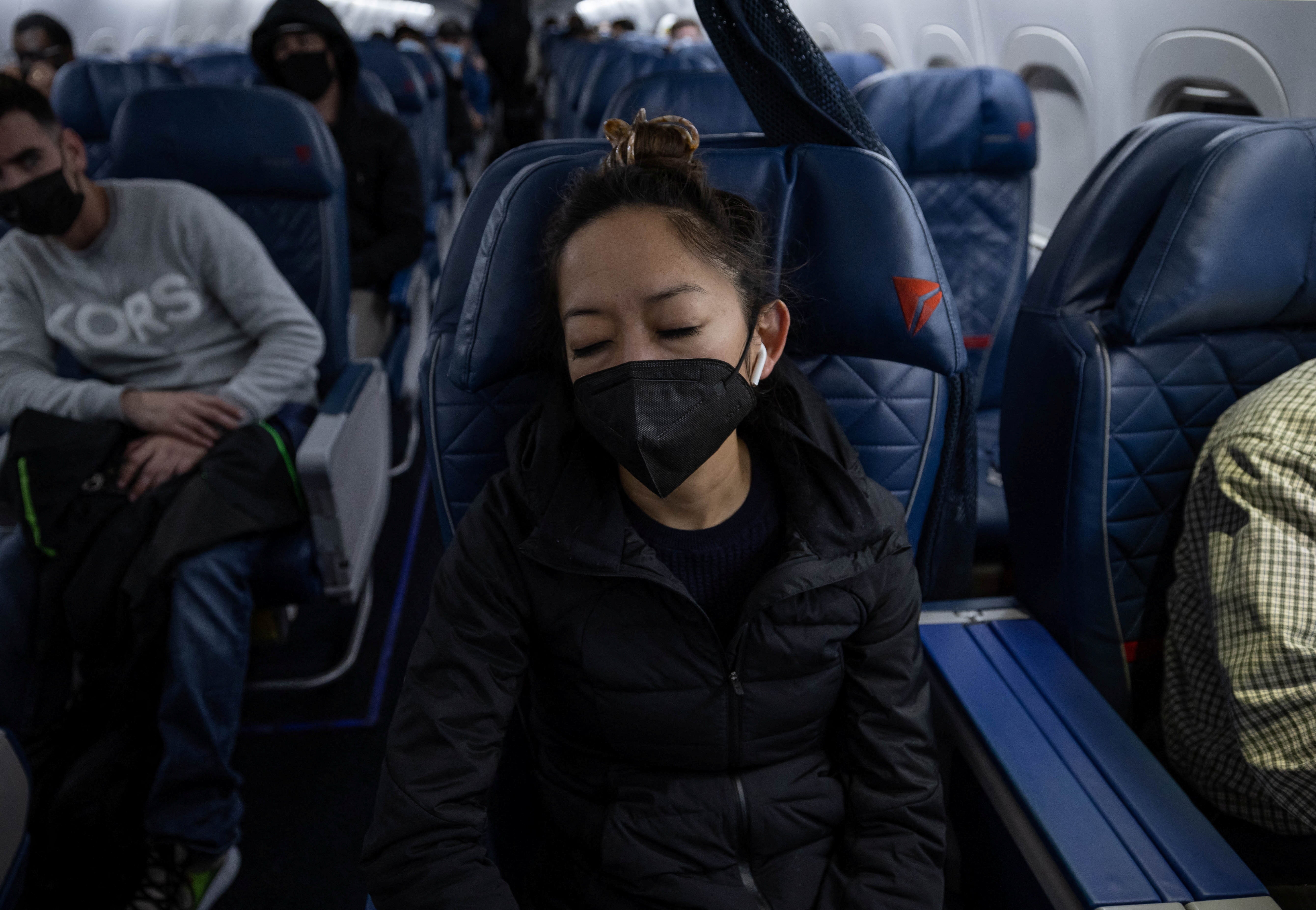 Tien sleeps on her flight from Birmingham, Alabama to Atlanta, Georgia