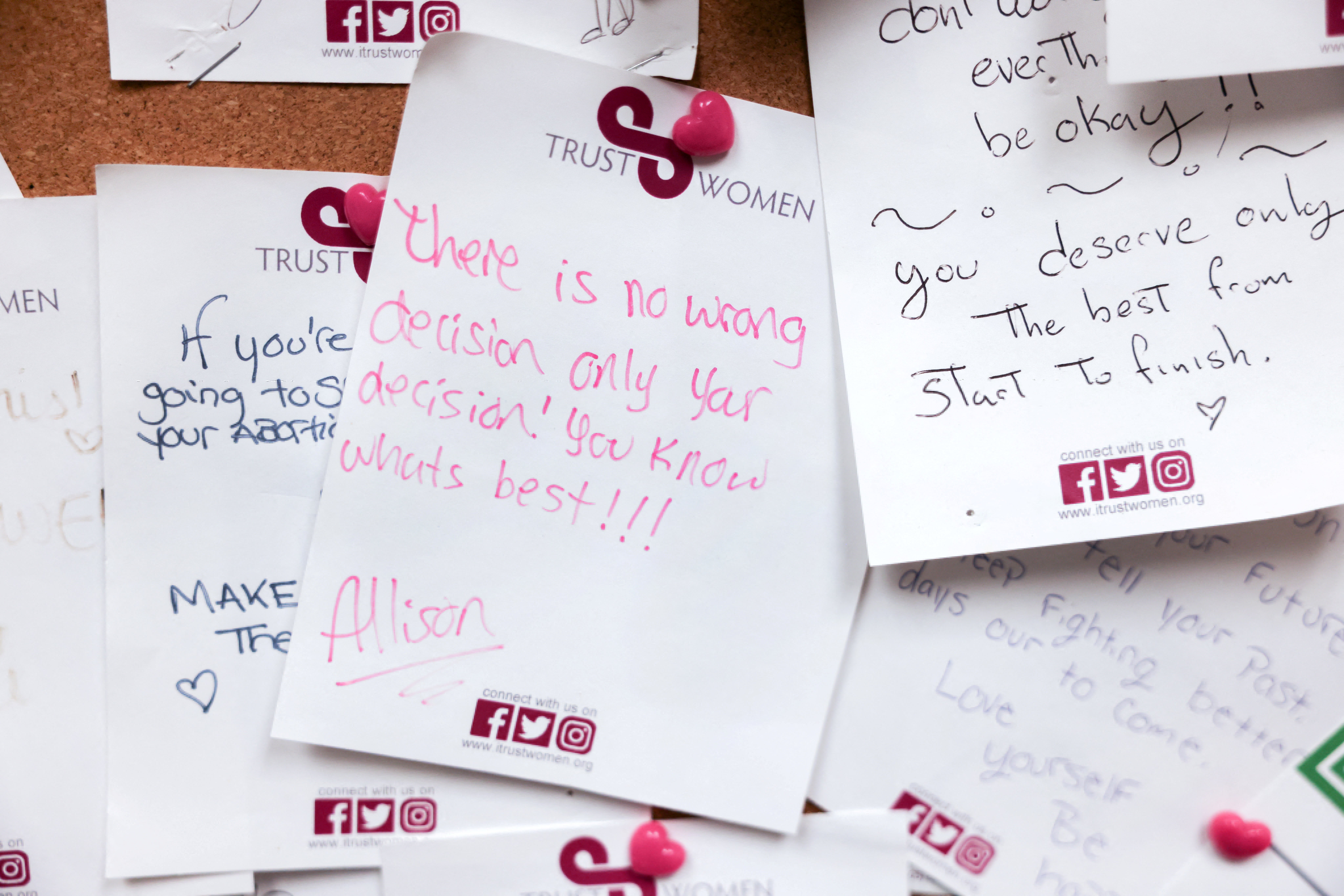 Handwritten notes of encouragement are pinned to the wall of a waiting room at the Trust Women clinic in Oklahoma City