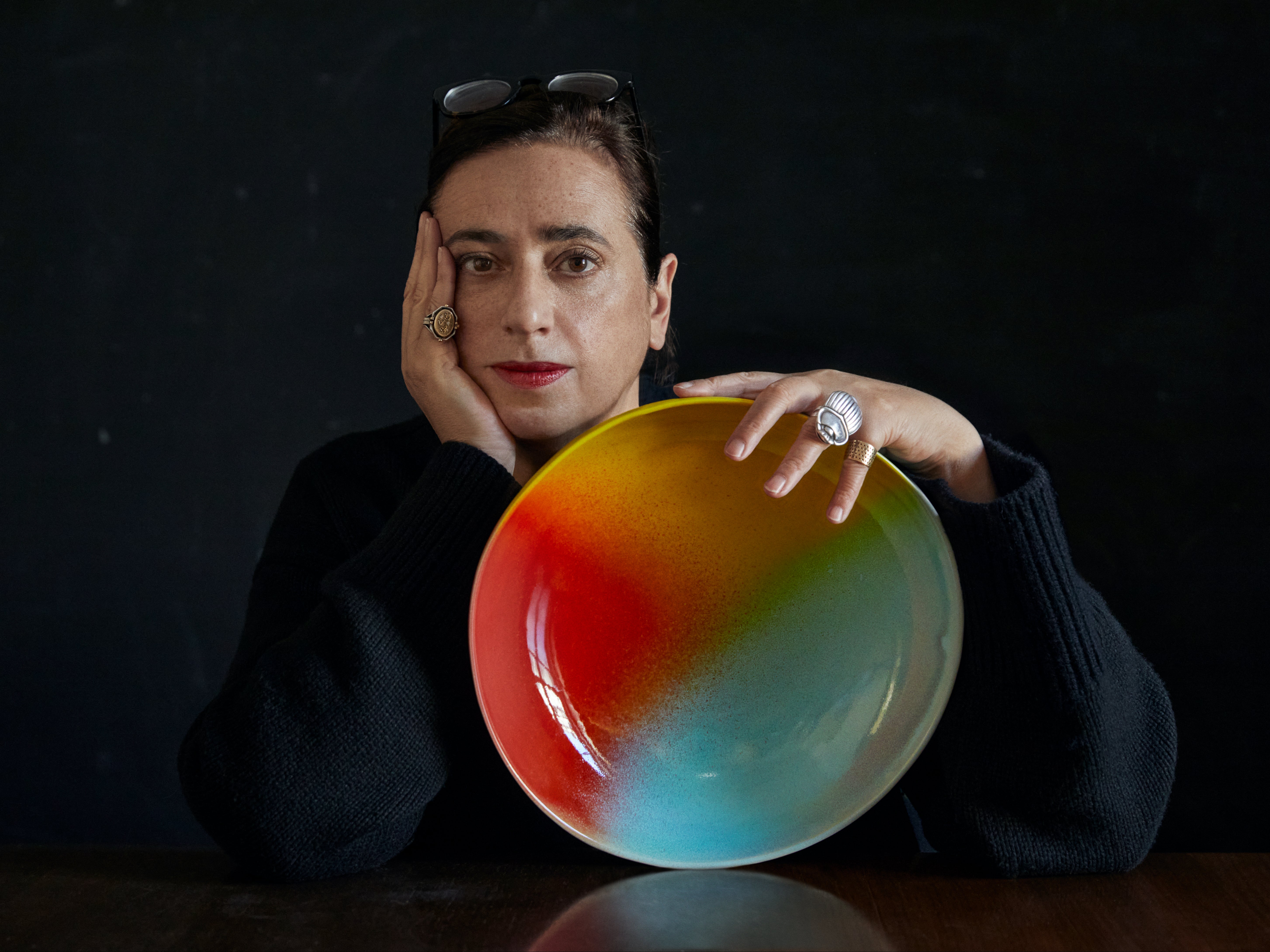 India Mahdavi with a rainbow plate from the collection