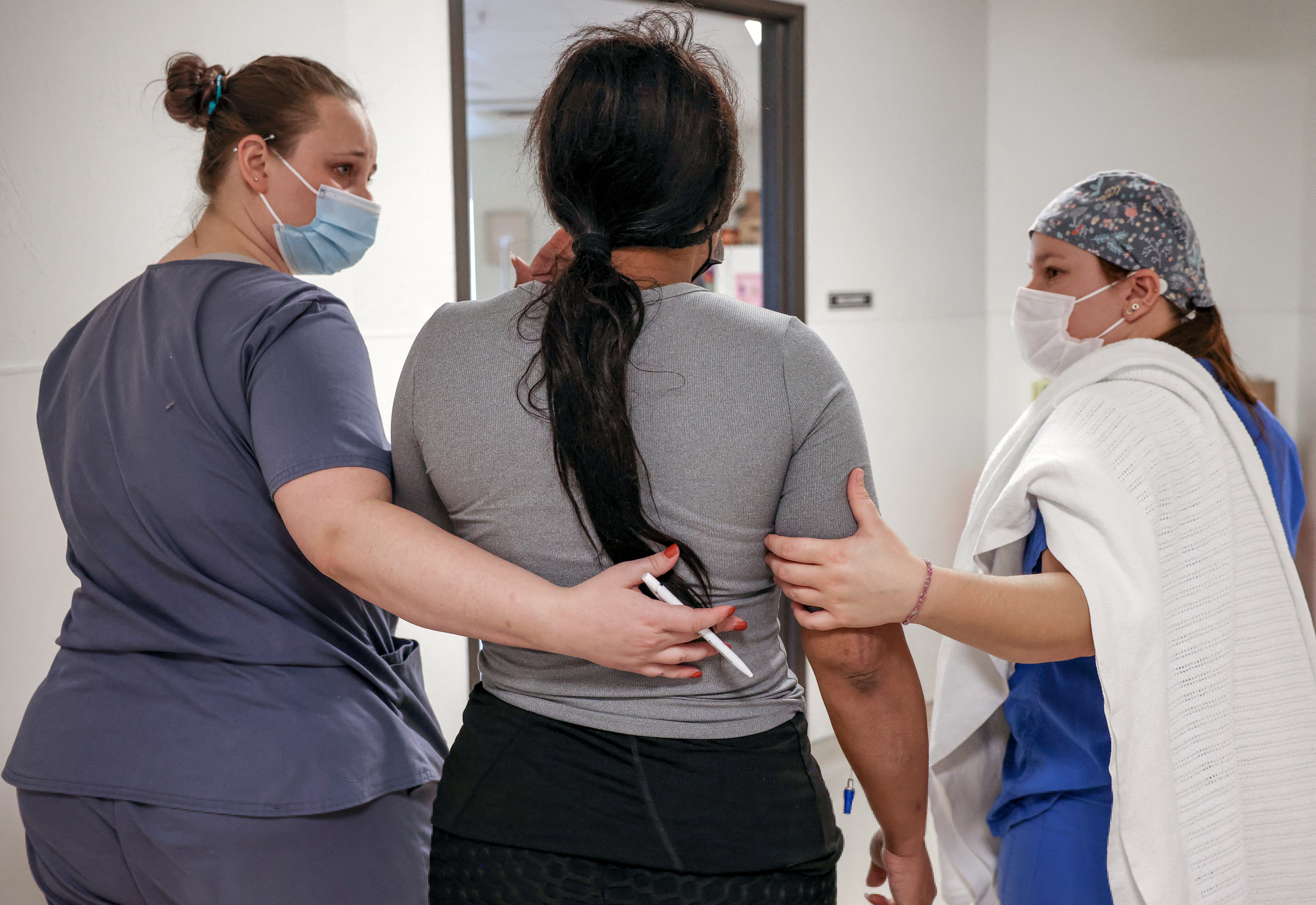 Surgical tech Carissa and recovery room staff member Elise walk a Texan patient to the recovery room following her abortion at the Trust Women clinic in Oklahoma City