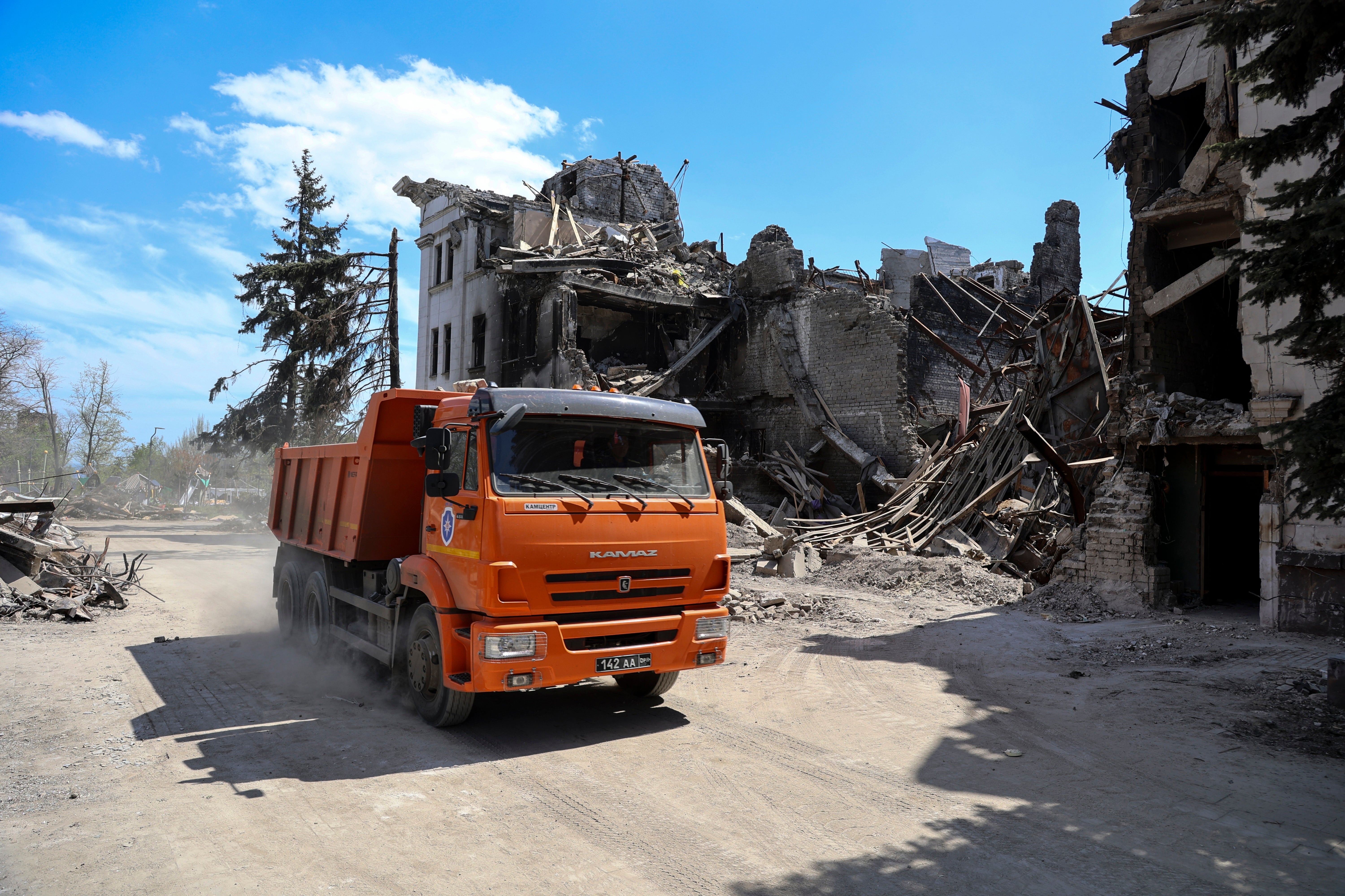 A truck drives past the Mariupol theater damaged during fighting in Mariupol, eastern Ukraine, April 27, 2022