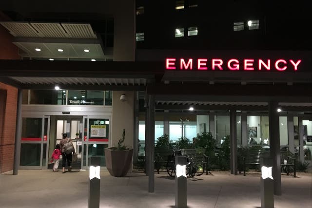 <p>People walk into the emergency room at a hospital in Tucson, Arizona, on November 5, 2019</p>