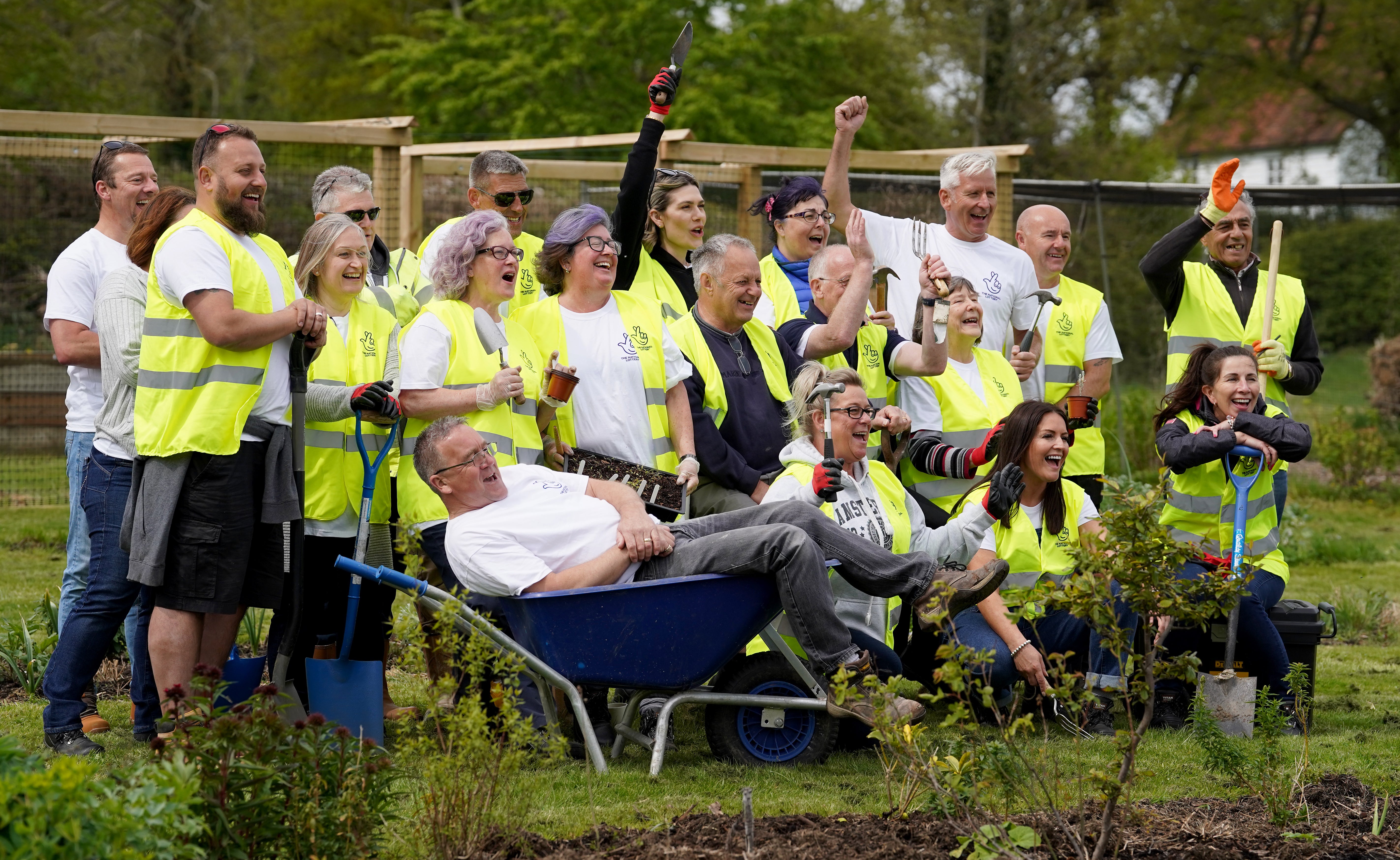 Twenty-one National Lottery winners, with a combined wealth of £146 million, help to lay paths and fences at Rocks Farm Oast, in Hastings, Sussex, after volunteering to help the Veterans’ Growth charity. Picture date: Thursday April 28, 2022 (Gareth Fuller/PA)