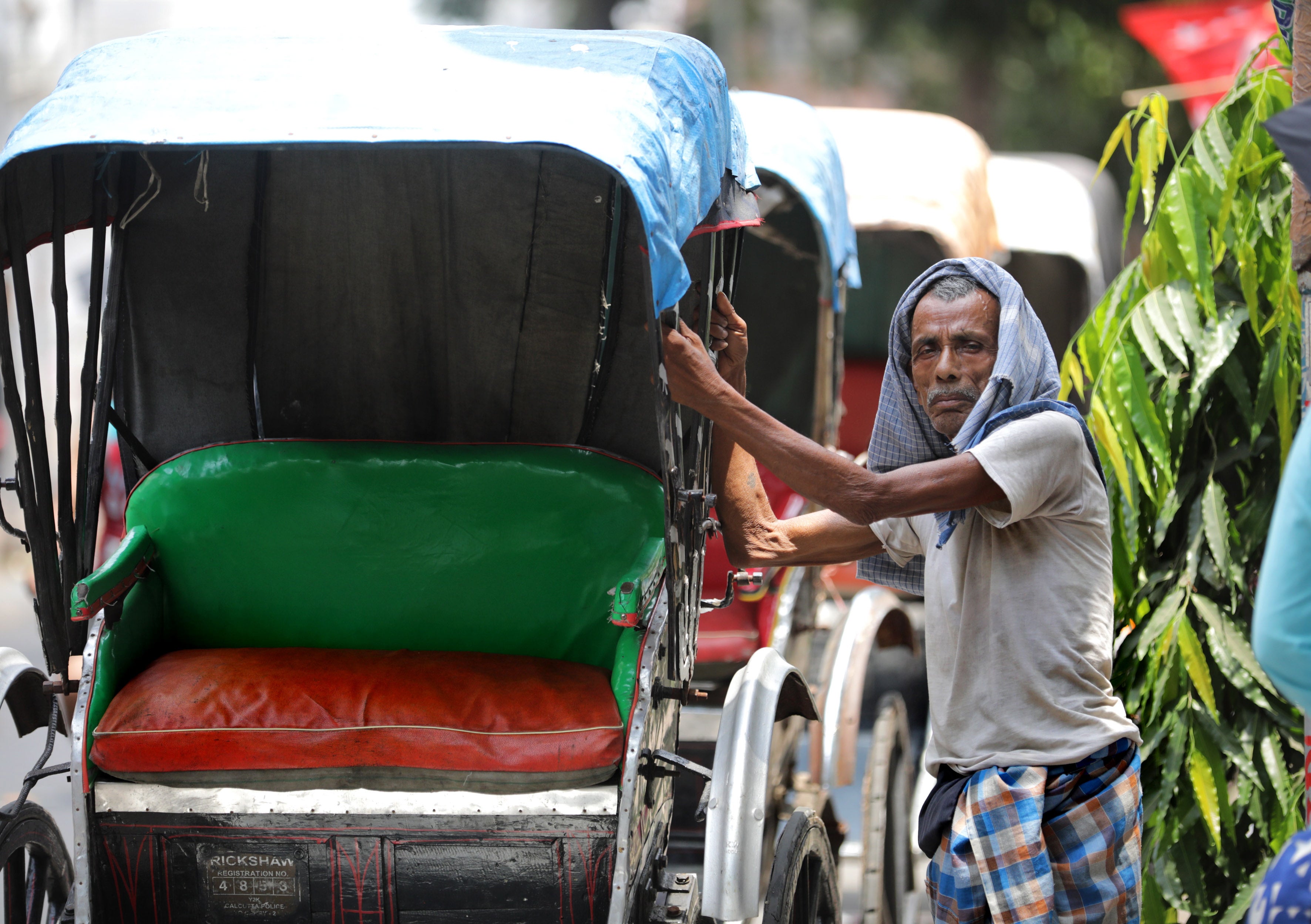 An rikshaw puller waits during a hot afternoon in Kolkata, eastern India on 19 April.