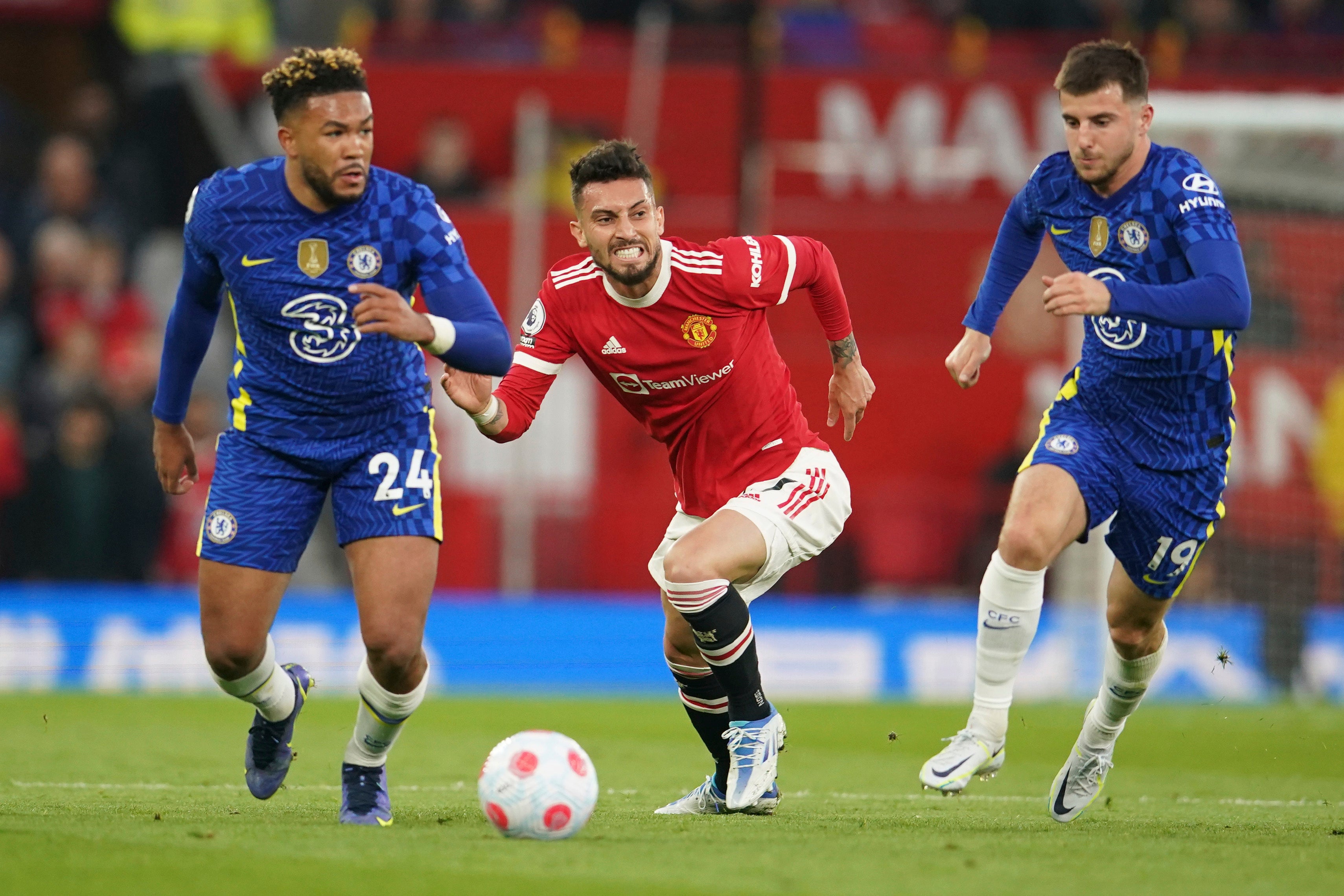 Alex Telles challenges for the ball with Reece James