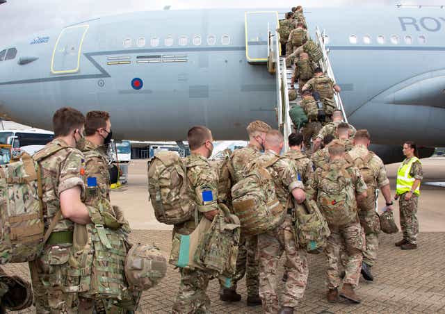 <p>UK military personnel board an RAF Voyager at RAF Brize Norton as around 8,000 British Army troops travel to exercises across eastern Europe</p>