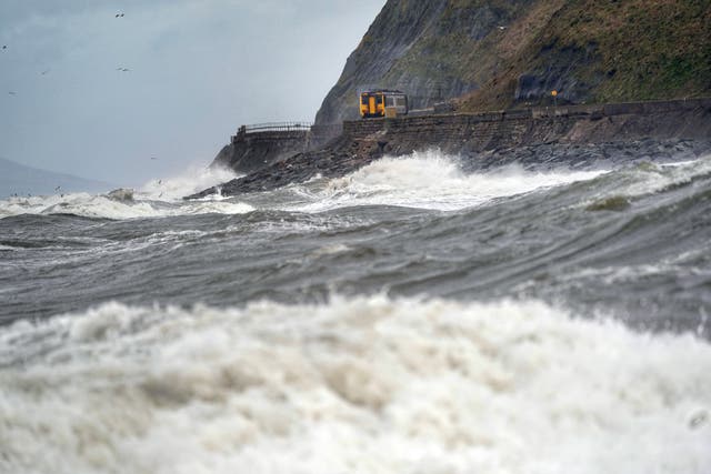 A train on west coast between Whitehaven and Carlisle in February. Insurers expect the bill for damage caused by Storms Dudley, Eunice and Franklin that hit much of the UK during February to amount to nearly £500 million (Owen Humphreys/PA)