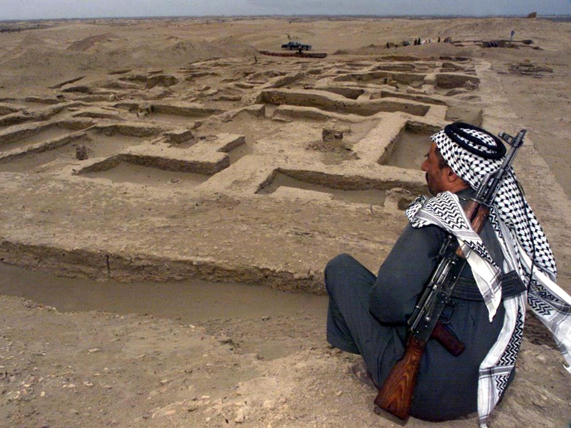 An armed Iraqi guard keeps an eye on a newly-discovered ancient Sumerian site in Um Alkarab