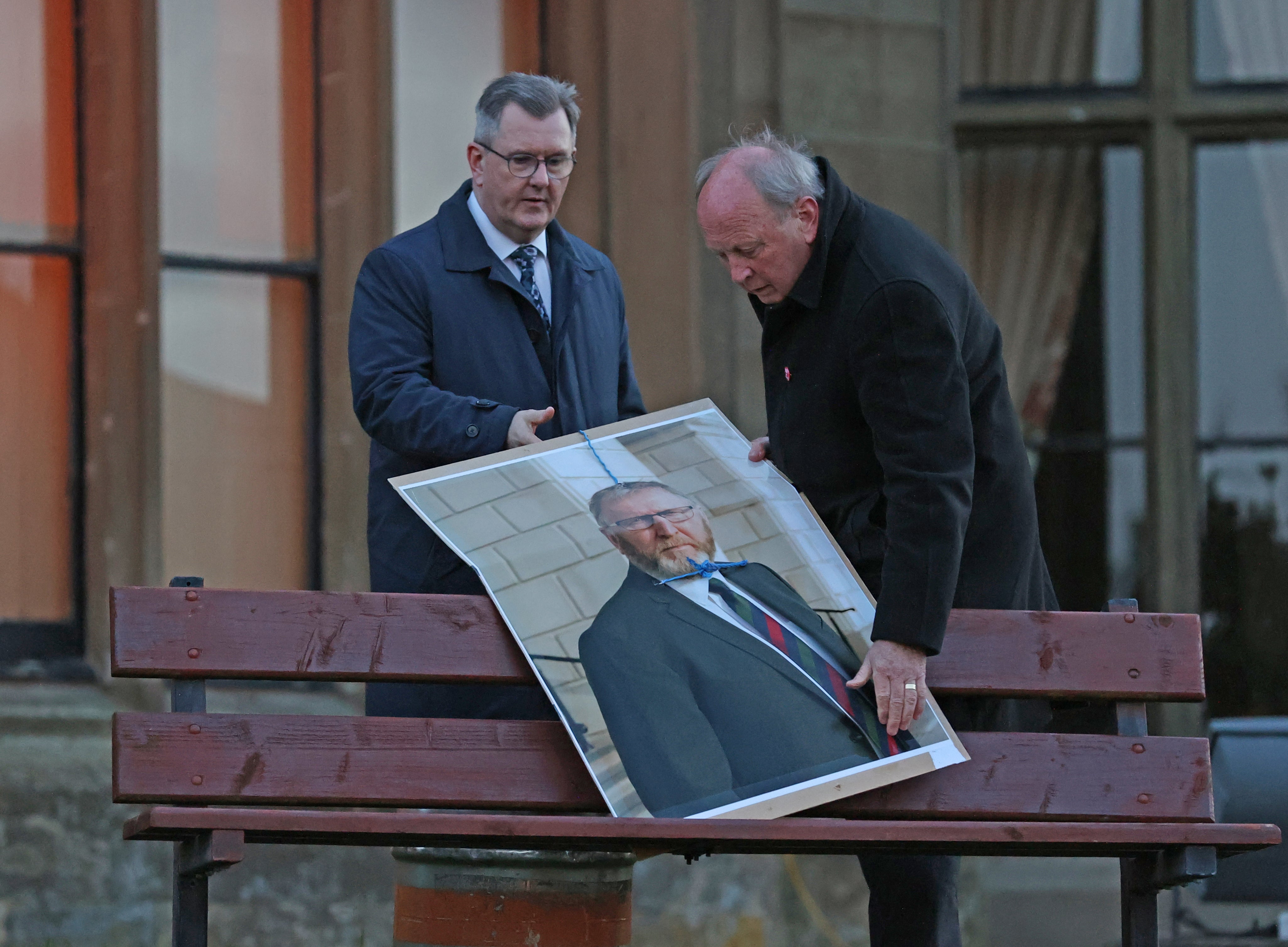 TUV leader Jim Allister (right) and DUP leader Sir Jeffrey Donaldson move from public view a poster of UUP leader Doug Beattie in noose at an anti-protocol rally (Liam McBurney/PA)