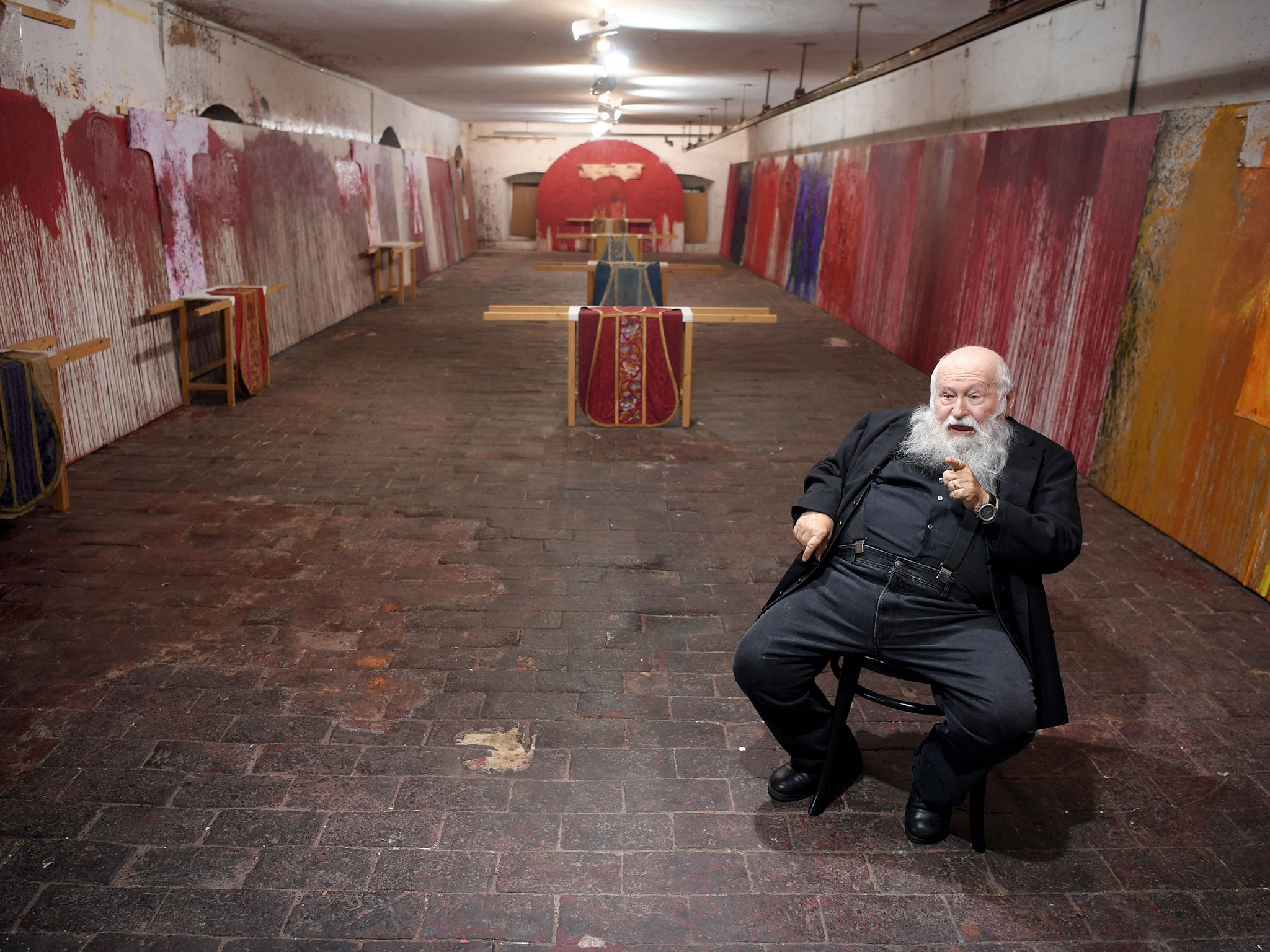 Nitsch pictured in 2018 with some of his troubling work