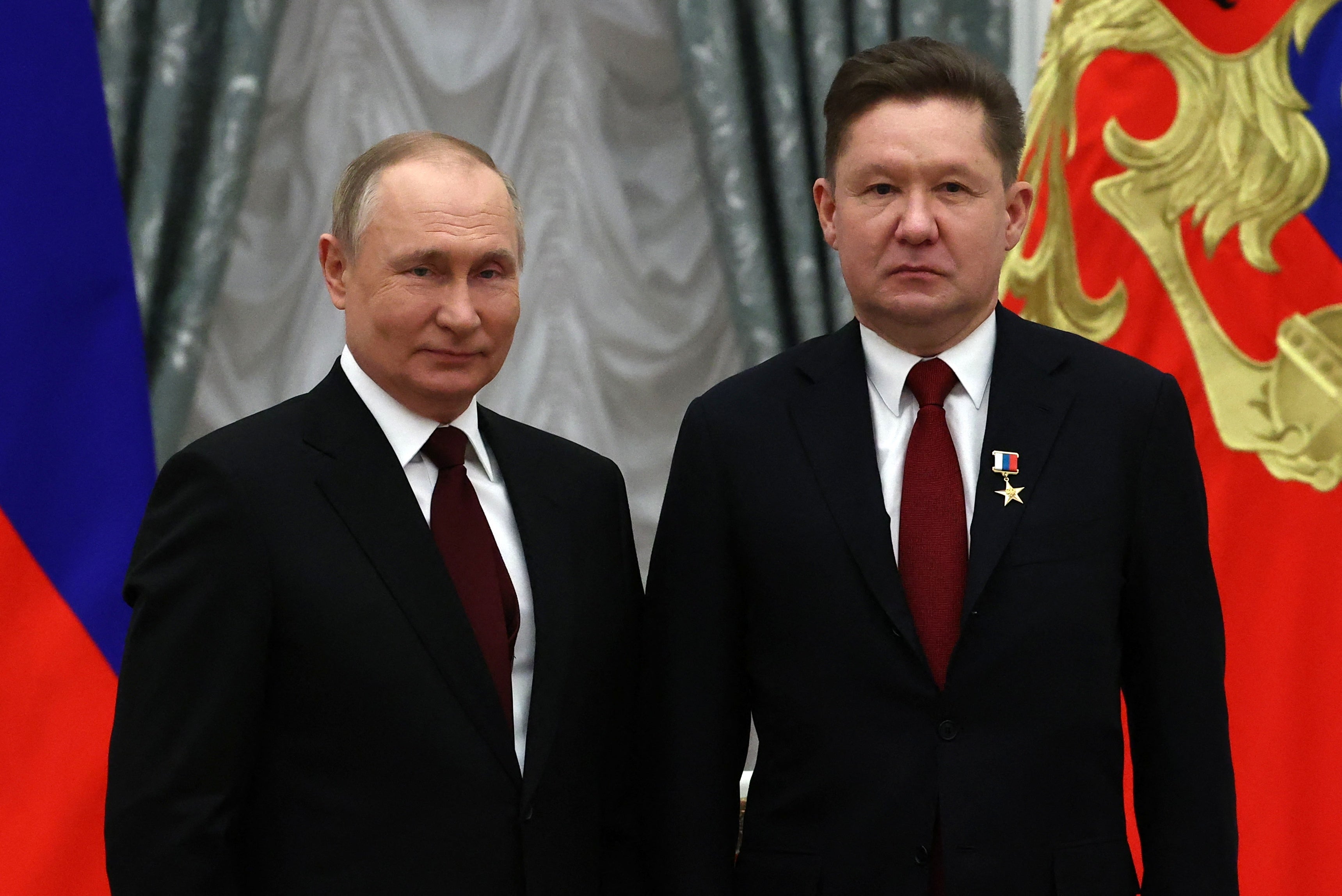 Vladimir Putin poses next to Gazprom CEO Alexey Miller after awarding him the title of ‘Hero of Labour of the Russian Federation’ during an award ceremony at the Kremlin