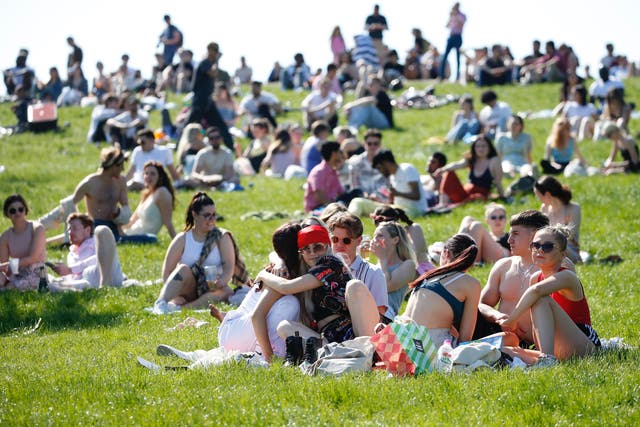<p>People bask in the sunshine at London’s Primrose Hill during last year’s May bank holiday</p>