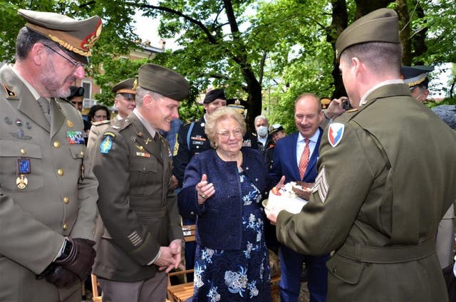 <p>Meri Mion, 90, receives a birthday cake from the US military in Vicenza, Italy, to replace the one American troops stole from her in 1945</p>