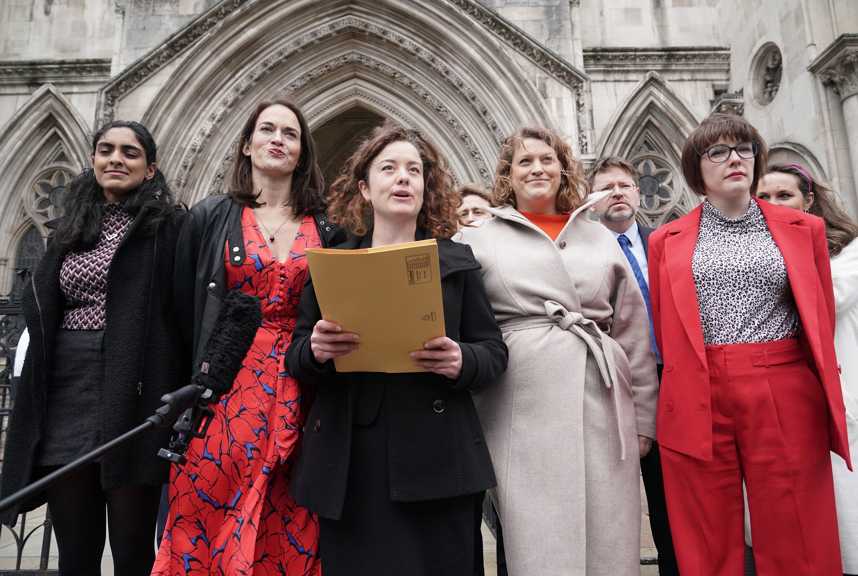 Solicitor Theodora Middleton (centre) of Bindmans LLP, reads a statement on behalf of Reclaim These Streets founders (left to right) Henna Shah, Jamie Klingler, Anna Birley and Jessica Leigh outside the Royal Courts of Justice after judges ruled that the Metropolitan Police breached the rights of the organisers of a vigil for Sarah Everard (Yui Mok/PA)