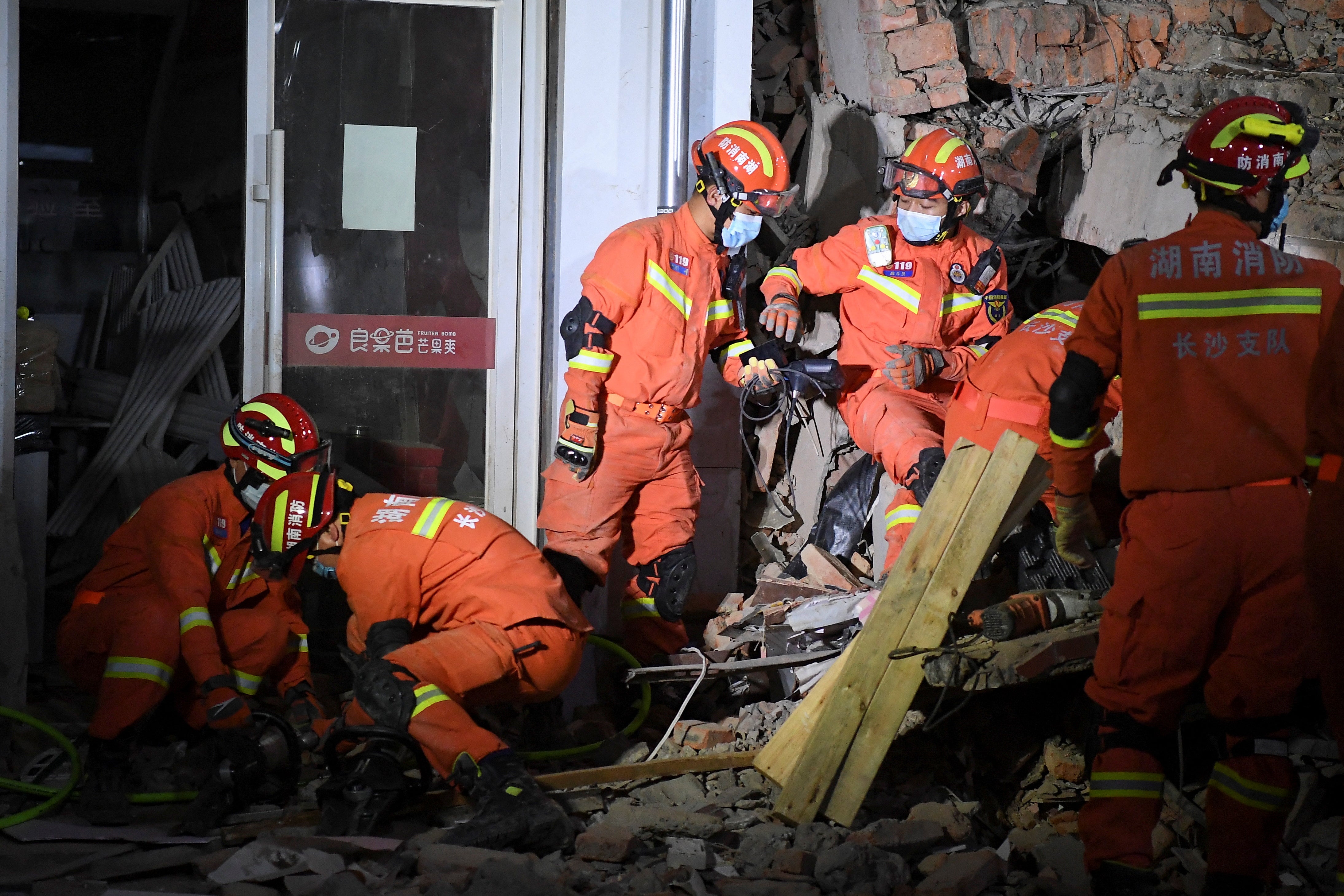 Rescue workers at the site of the collapsed building in Changsha