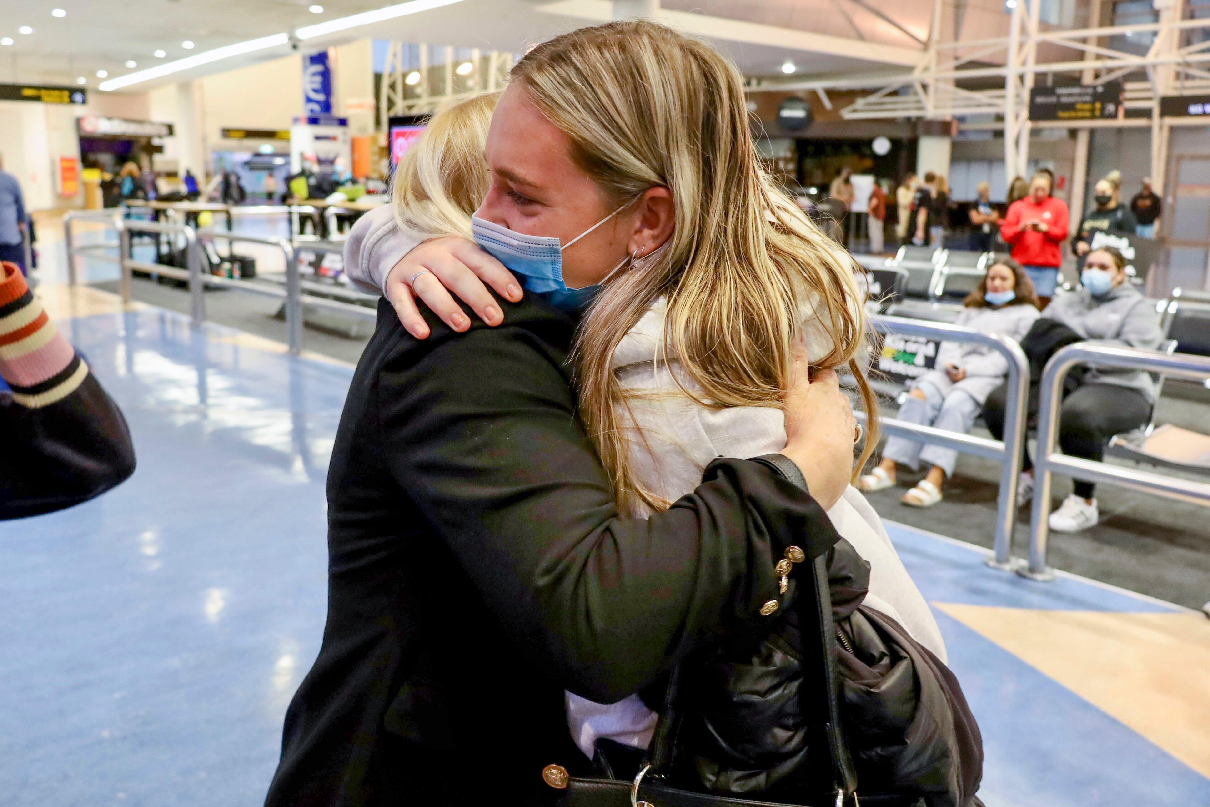 Families embrace after a flight from Los Angeles arrived at Auckland International Airport, as New Zealand’s border opened for visa-waiver countries Monday, 2 May 2022