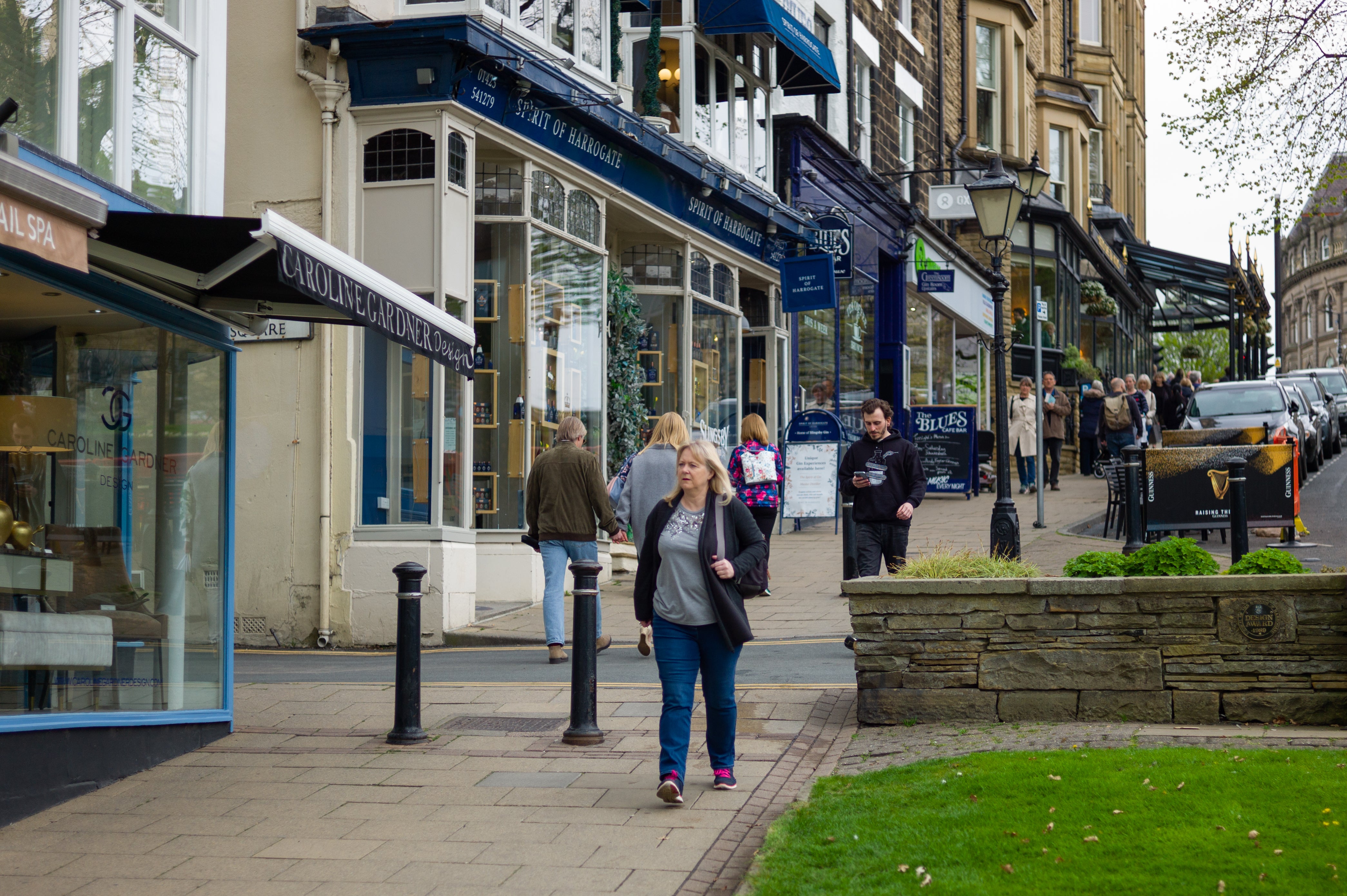 People walk past independent retail shops in the Montpellier Quarter of Harrogate