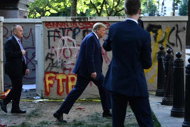 <p>US President Donald Trump walks back to the White House escorted by the Secret Service after appearing outside of St John's Episcopal church across Lafayette Park in Washington, DC on June 1, 2020</p>