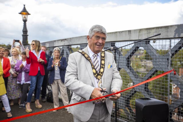 Councillor Billy Webb cutting the red ribbon (Liam McBurney/PA)