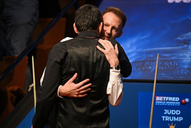 <p>Judd Trump (right) and Ronnie O’Sullivan shared a long embrace after the World Championship final </p>