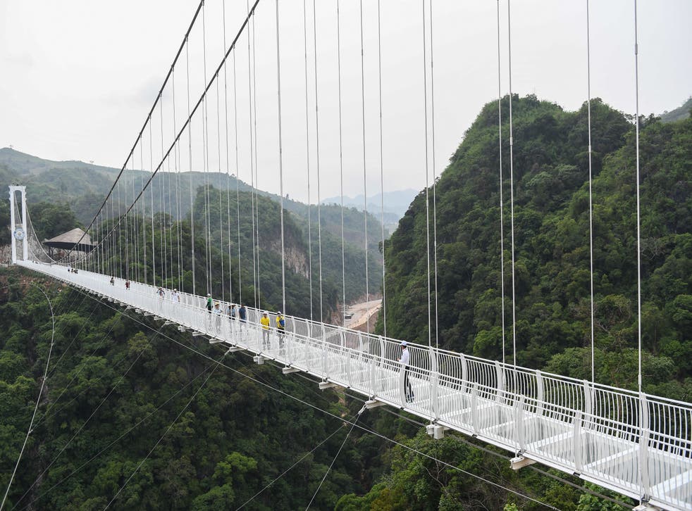 <p>Visitors walk on the Bach Long glass bridge in Moc Chau district in Vietnam’s Son La province</p>