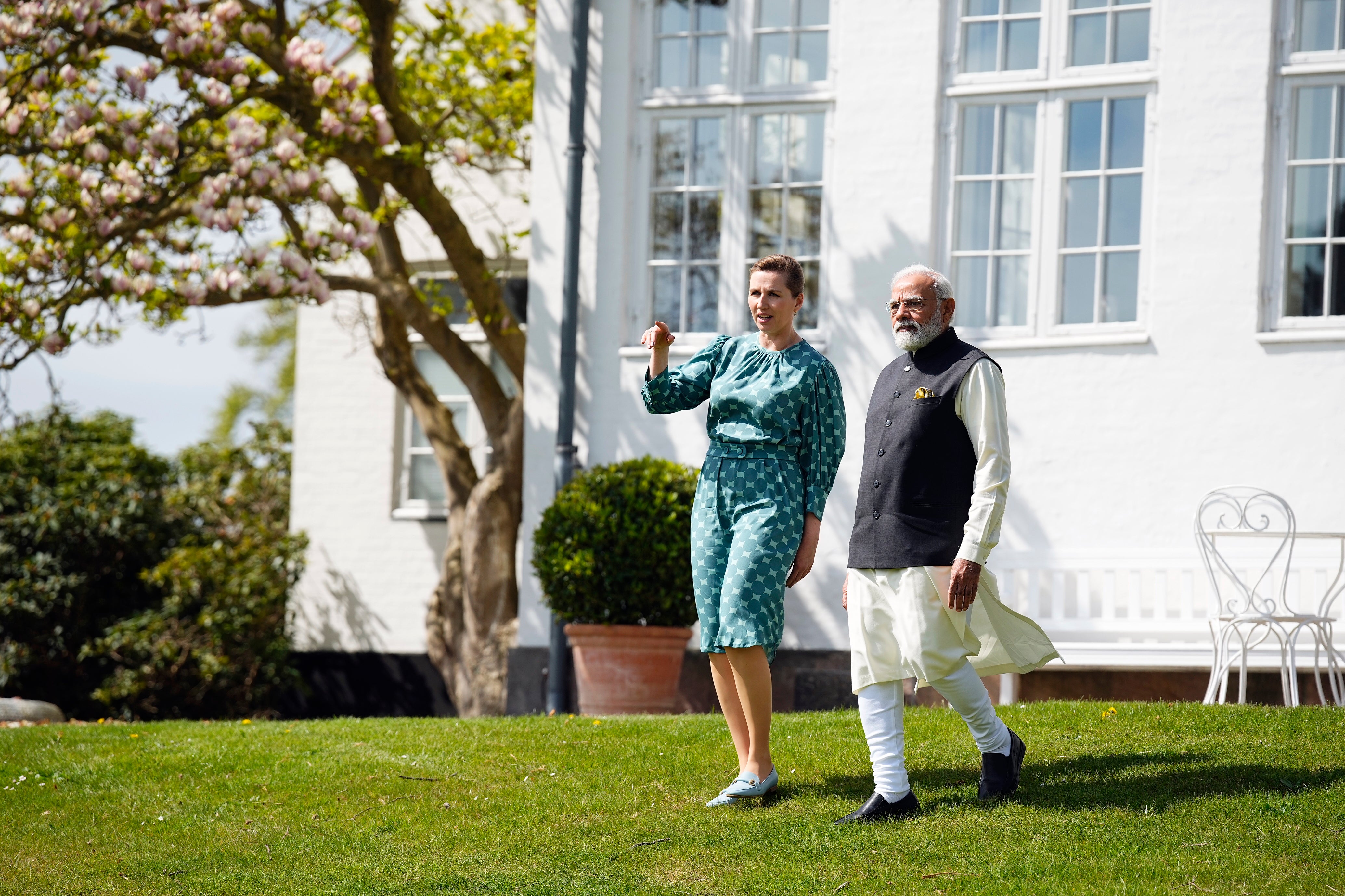 Danish prime minister, Mette Frederiksen, and Narendra Modi talk in the garden in Kongens Lyngby, north of Copenhagen