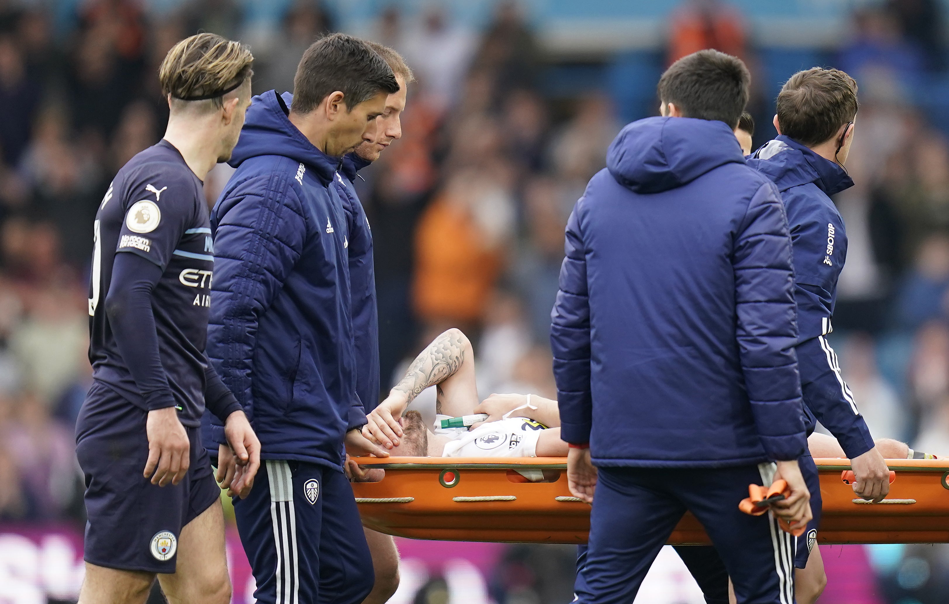 Leeds’ Stuart Dallas is taken off on a stretcher after breaking his leg against Manchester City (Danny Lawson/PA)