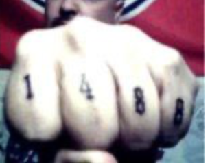 A 1488 white supremacist gang member displays tattoos featuring Nazi numeric symbols