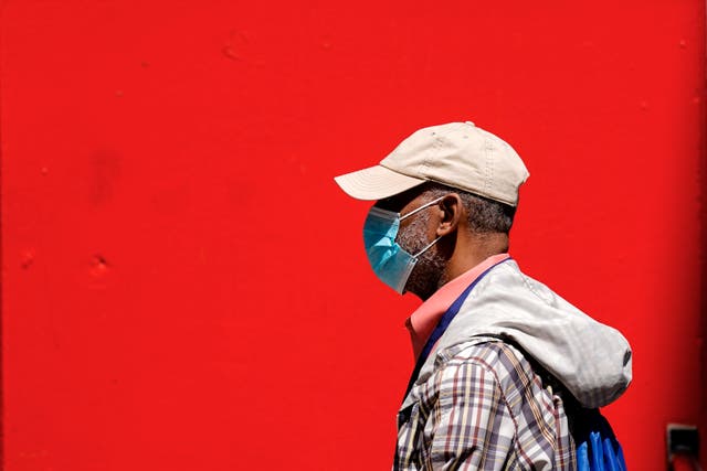 <p>A pedestrian wearing a protective mask as a precaution against the spread of the coronavirus walks in Philadelphia, Friday, April 22, 2022</p>