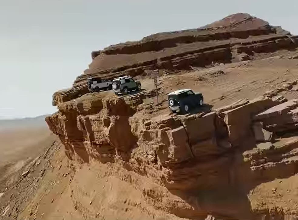 A scene from the Land Rover ad showing the vehicles parking on a cliff edge. (Jaguar Land Rover/PA)