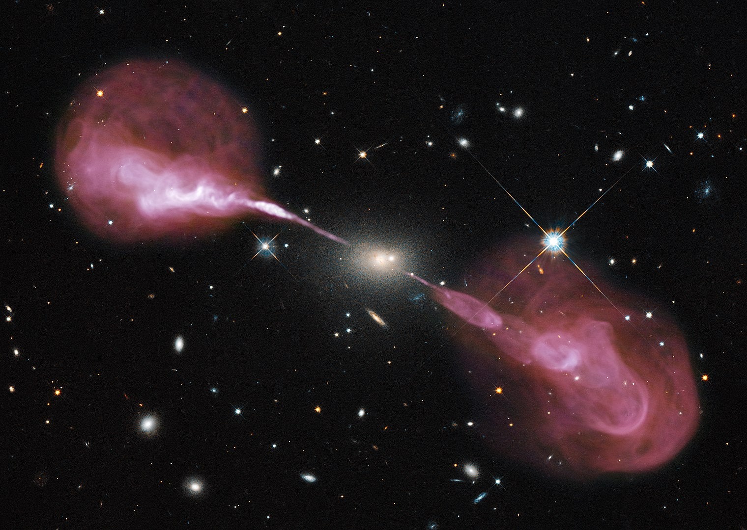 A radio image shows energy streaming from the heart of radio galaxy Hercules A