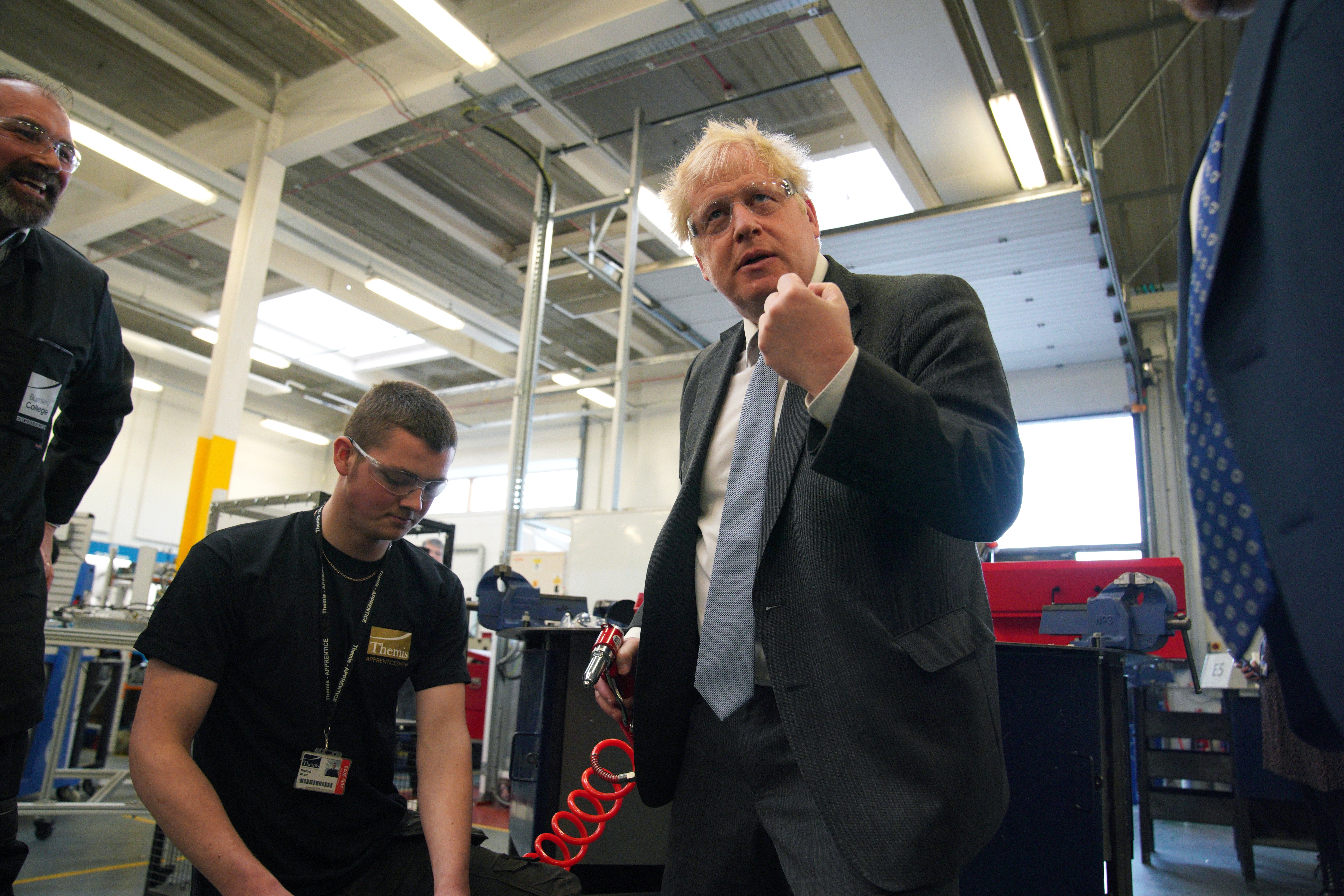 Prime Minister Boris Johnson holds a rivet gun during a campaign visit to Burnley College Sixth Form Centre (Peter Byrne/PA)