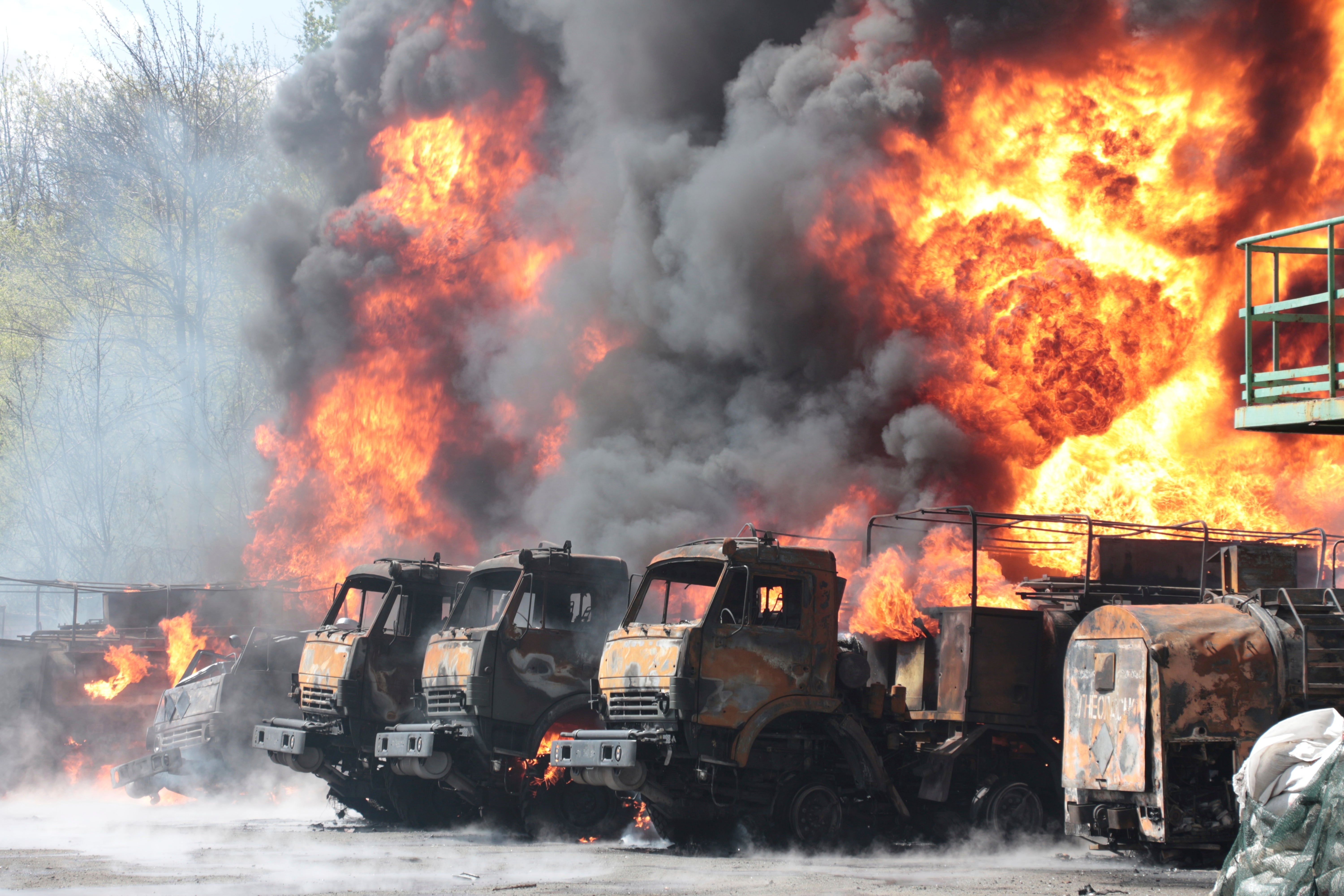 Vehicles on fire at an oil depot in eastern Ukraine
