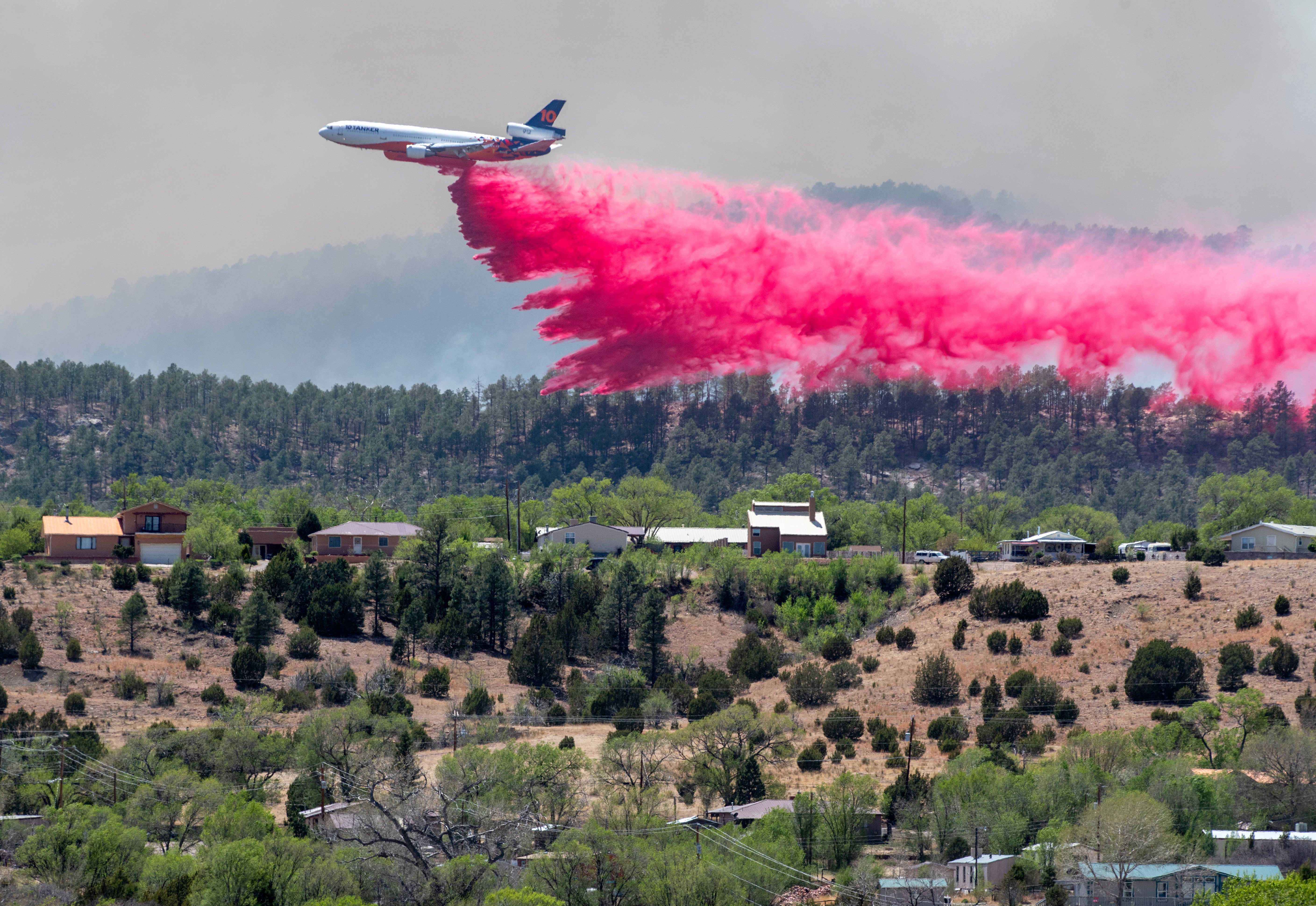 A plane drop flame retardant near Las Vegas, New Mexico on Tuesday