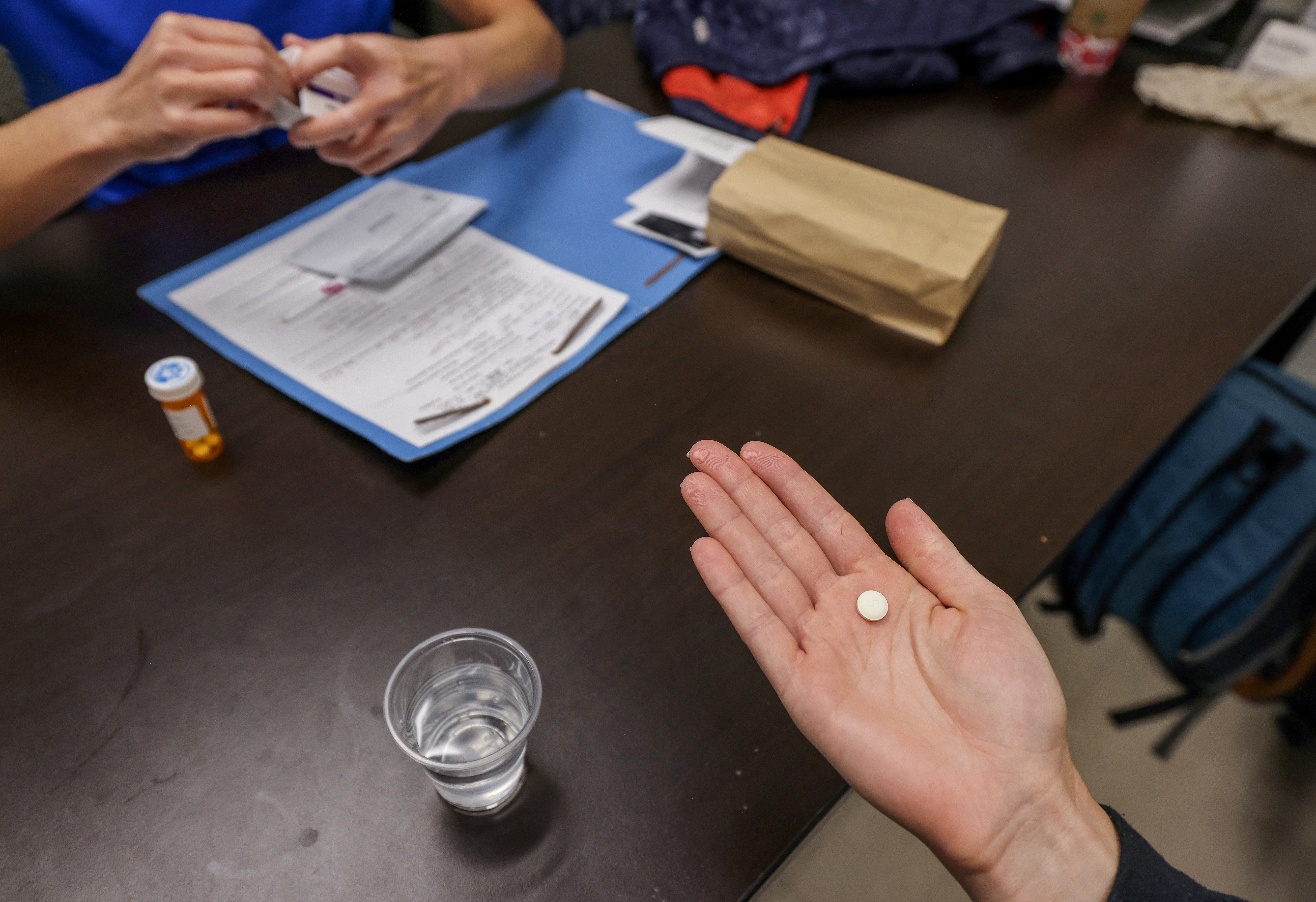 Dr Shelly Tien hands a patient abortion medication at the Trust Women Foundation clinic in Oklahoma City in December 2021.