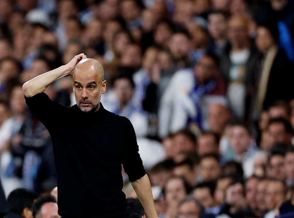 <p>Pep Guardiola looks dejected during the second leg of the Champions League semi-final</p>