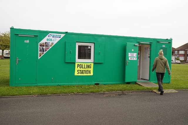 A woman arrives at a polling station in a temporary building in Whitley Bay, Northumberland (Owen Humphreys/PA)