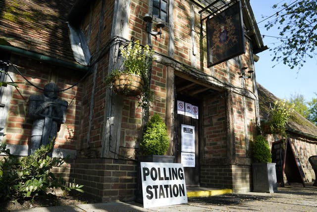 <p>A polling station at the Crown and Cushion pub near Camberley in Surrey (Andrew Matthews/PA)</p>
