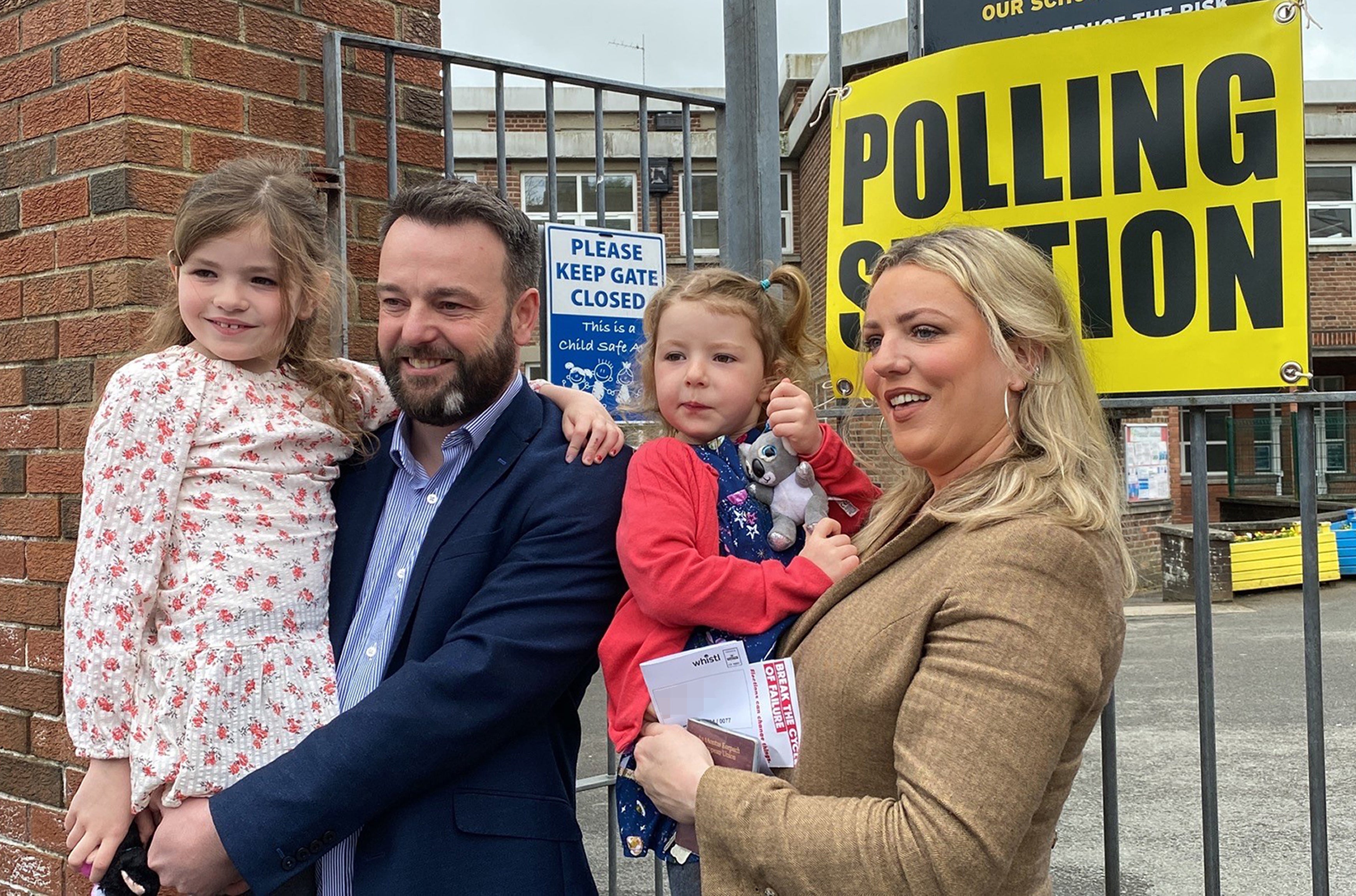 SDLP leader Colum Eastwood arrives to cast their vote in the 2022 NI Assembly election with his wife Rachael and children, Rosa, six, and Maya, four, in the Foyle constituency in Londonderry (Dominic McGrath/PA)