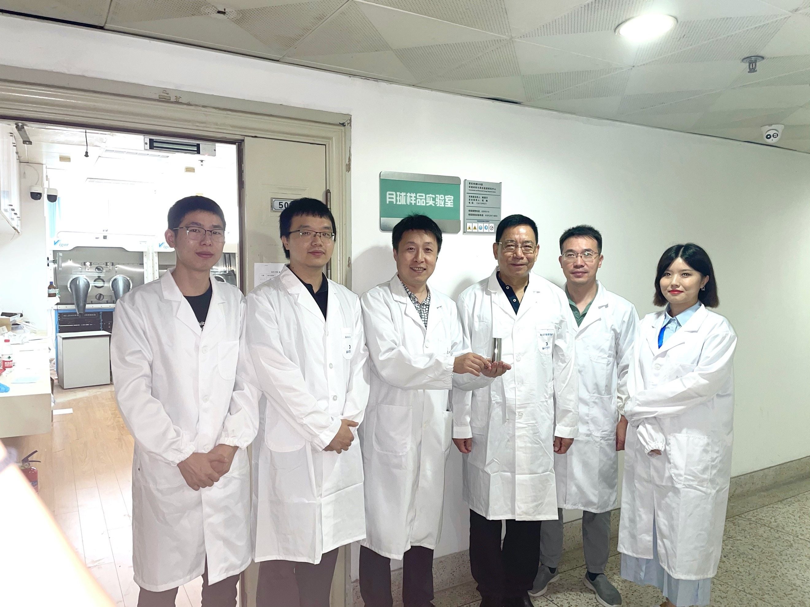 The team at Nanjing University holds the lunar soil sample