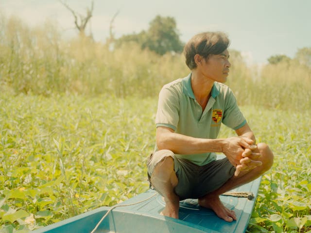 <p>Lim Ny on his boat in the backyard of his home, Phat Sanday floating village</p>