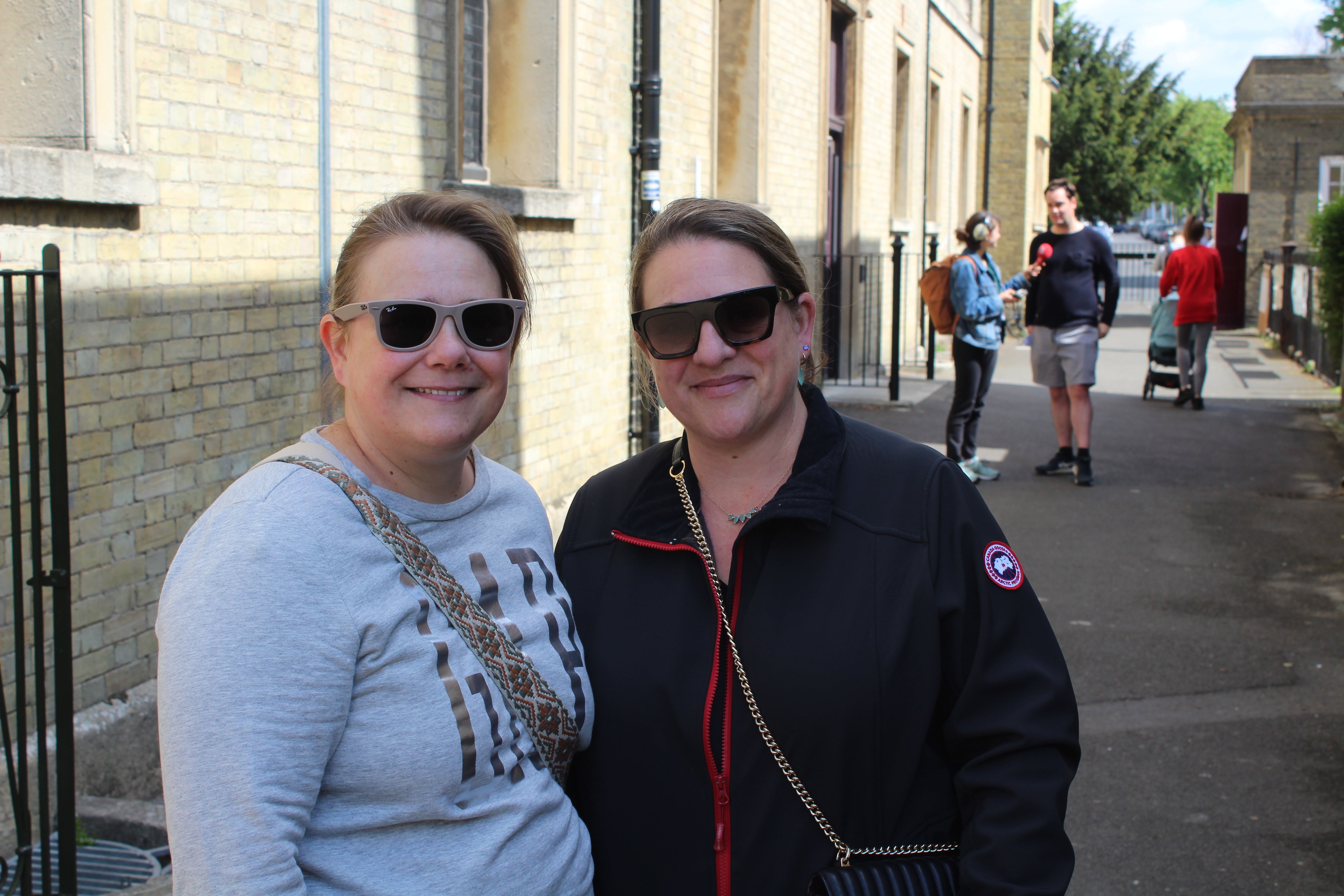 Katia (L) and Helen (R) Themistocleous stand outside a polling station in Wandsworth, London