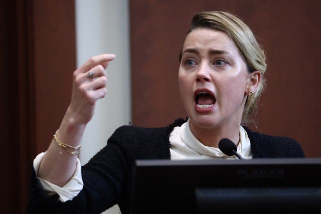 <p>Actor Amber Heard reacts on the stand in the courtroom at Fairfax County Circuit Court during a defamation case against her by ex-husband, actor Johnny Depp, in Fairfax, Virginia, U.S., May 5, 2022</p>