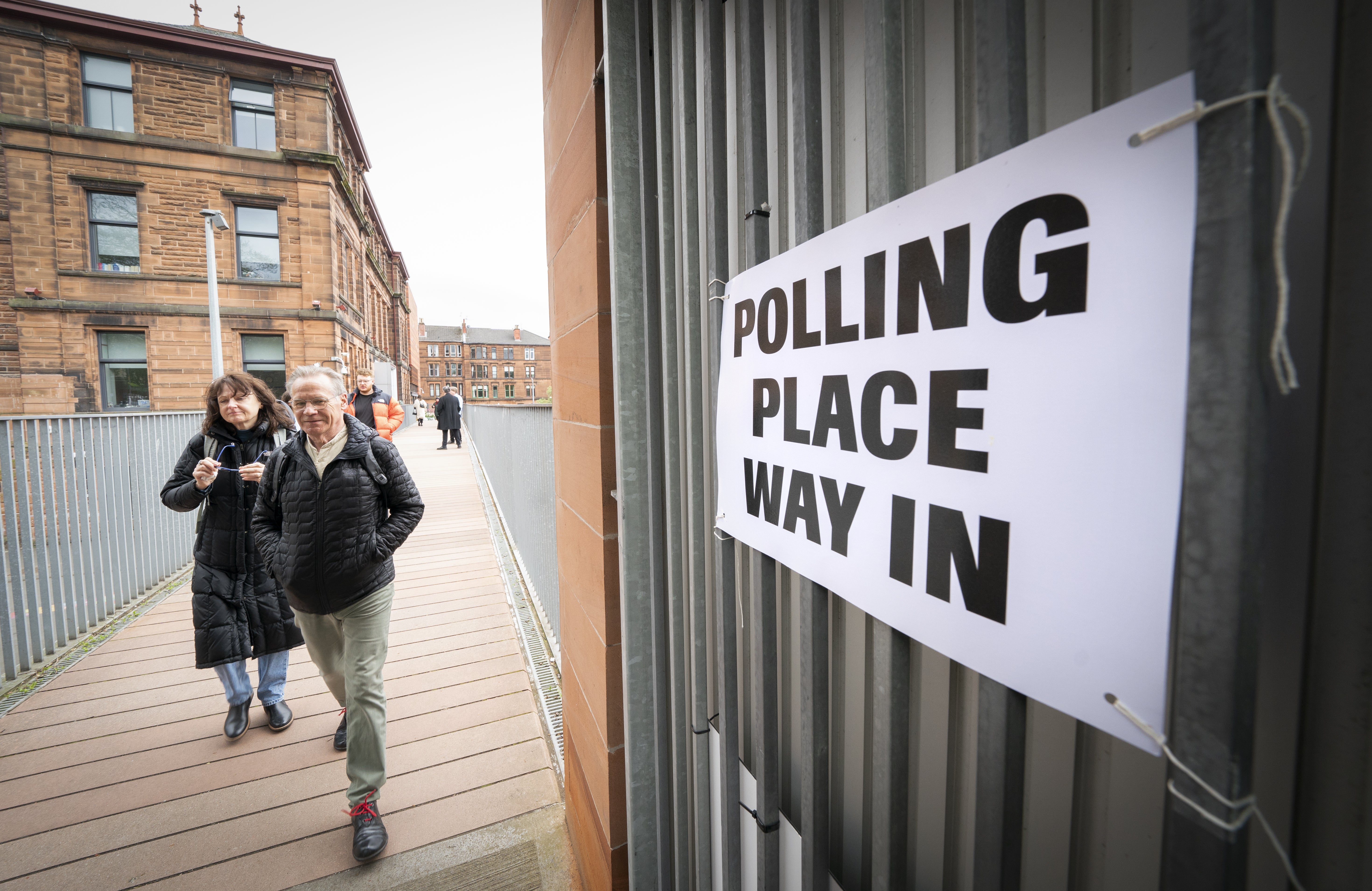 Voters outside the polling station at Notre Dame Primary School in Glasgow as votes are cast in the local government elections (PA)