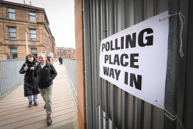 Voters outside the polling station at Notre Dame Primary School in Glasgow as votes are cast in the local government elections (PA)