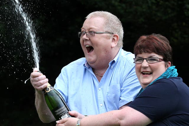 <p>Colin and Chris Weir, from Largs in Ayrshire, celebrate after they scooped £161 million </p>