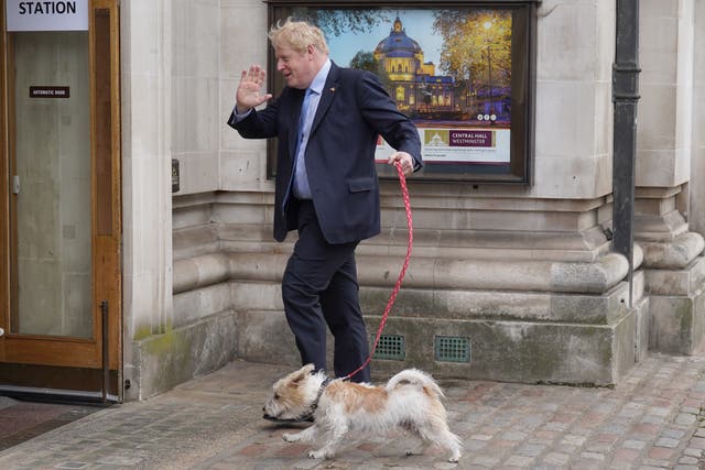 Prime Minister Boris Johnson arrives with his dog Dilyn to vote at Methodist Central Hall, central London, in the local government elections. Picture date: Thursday May 5, 2022.
