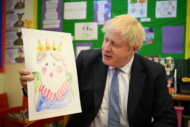 <p>Boris Johnson with the portrait he painted of the Queen during a visit to Field End Infant School in South Ruislip</p>