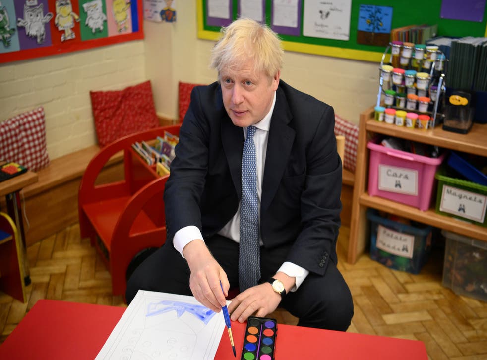 Boris Johnson paints a portrait of the Queen during a visit to Field End Infant school, in South Ruislip (Daniel Leal/PA)